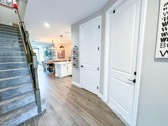 7537 Carnegie Way Naples, FL 34119 - Photo 4 of 35 a view of a room with wooden floor and staircase