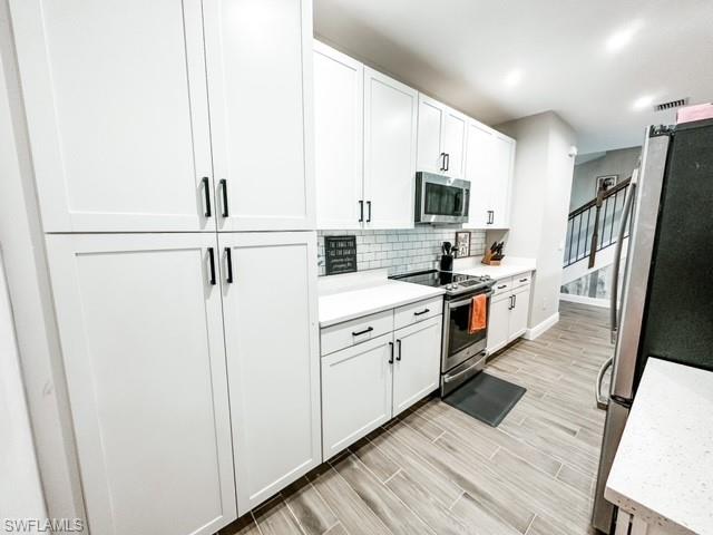7537 Carnegie Way Naples, FL 34119 - Photo 7 of 35 a kitchen with stainless steel appliances a refrigerator sink and microwave