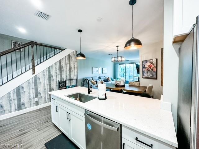 7537 Carnegie Way Naples, FL 34119 - Photo 8 of 35 a kitchen with sink a counter and cabinets