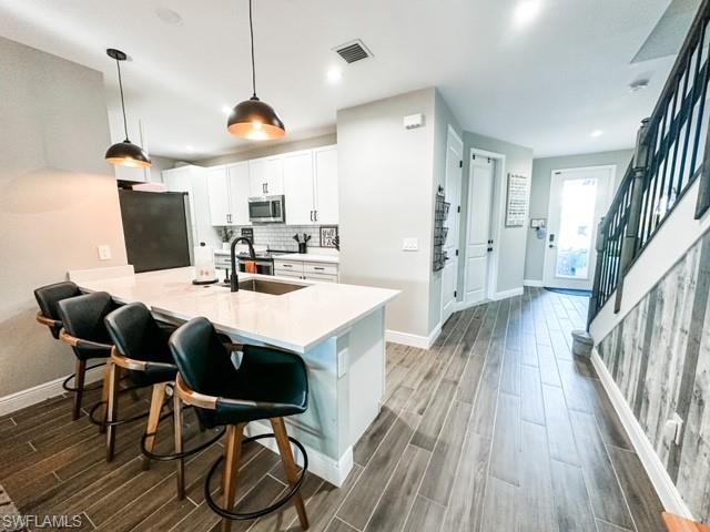 7537 Carnegie Way Naples, FL 34119 - Photo 9 of 35 a view of a dining room with furniture window and wooden floor