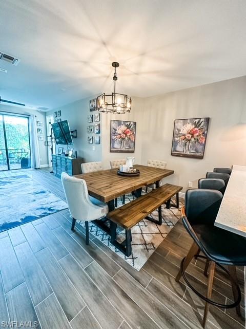 7537 Carnegie Way Naples, FL 34119 - Photo 10 of 35 a living room with furniture a rug and a chandelier