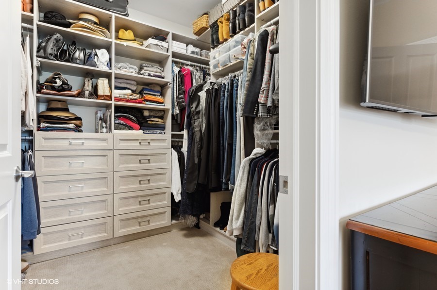 1884 Old Willow Road, Unit 2B Northfield, IL 60093 - Photo 12 of 17 a view of walk in closet with clothes and shoes