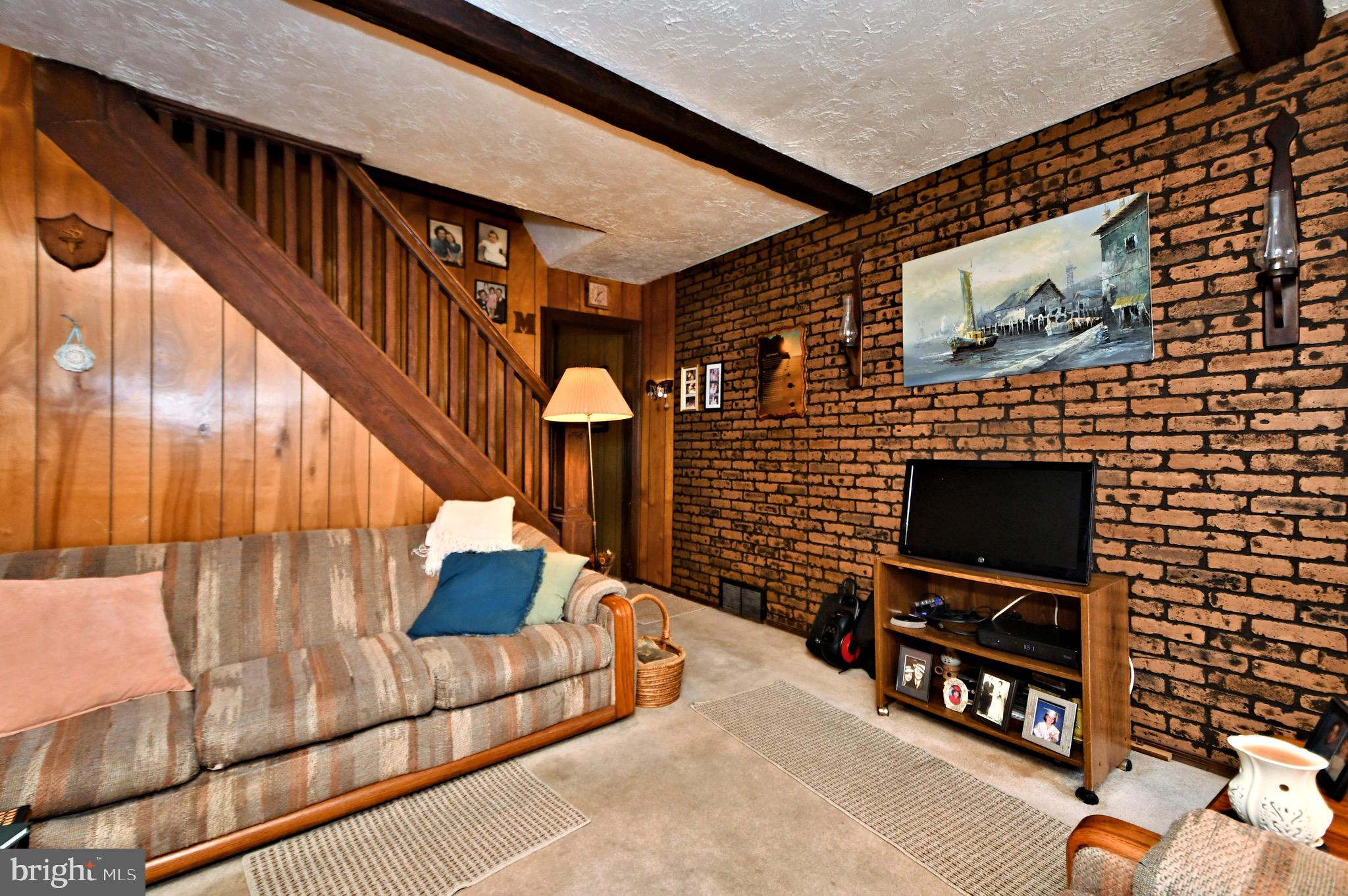 447 Ripka Street Philadelphia, PA 19128 - Photo 8 of 44 a living room with fireplace furniture and a flat screen tv