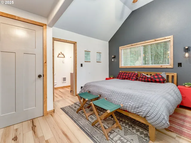 a bed sitting in a bedroom next to a window
