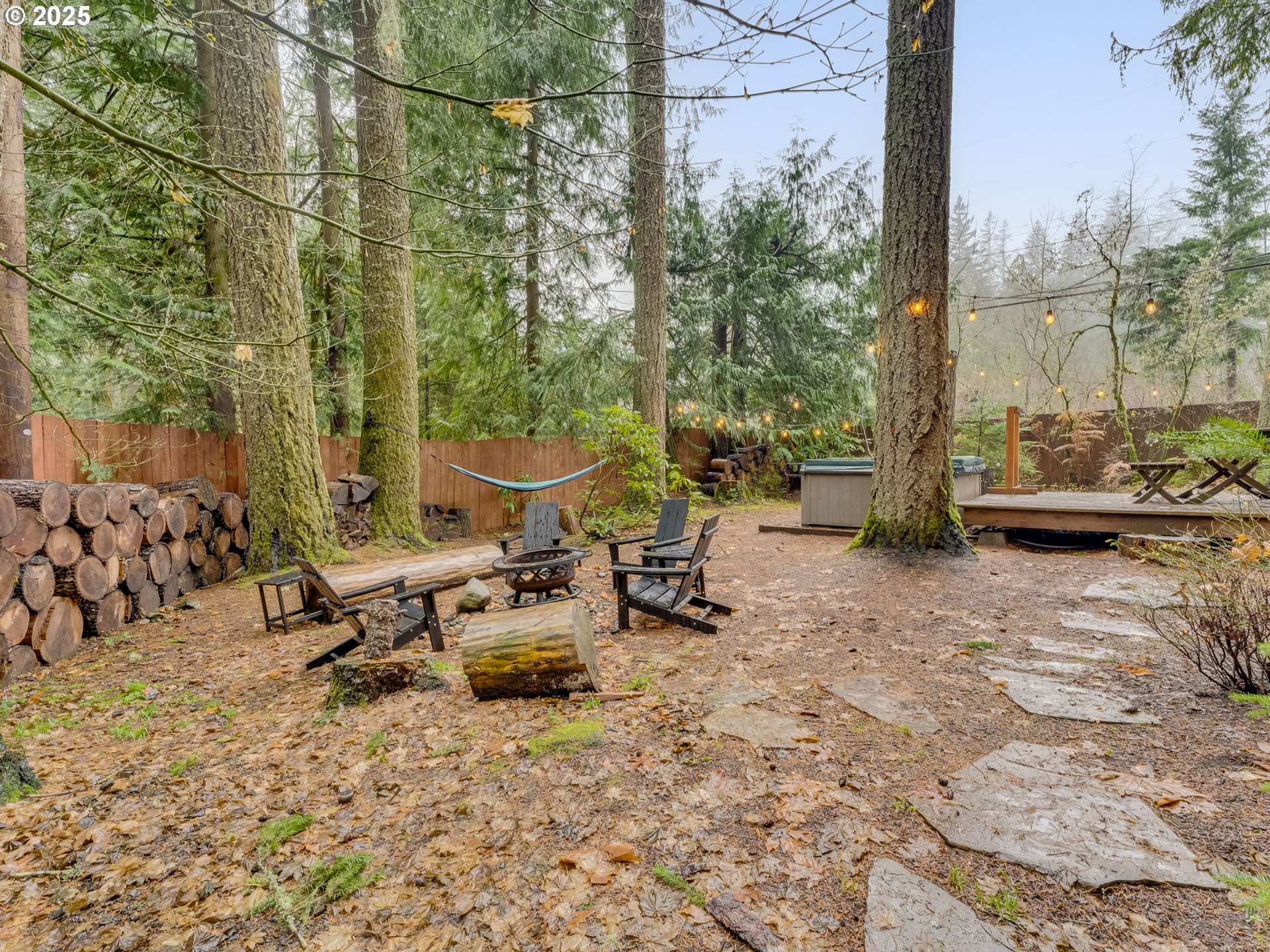 71597 East Minikahda Avenue Rhododendron, OR 97049 - Photo 20 of 26 a view of a patio with table and chairs and floor to ceiling window