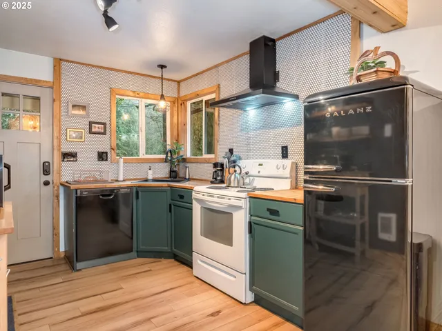 a kitchen with cabinets and stainless steel appliances
