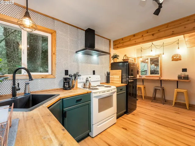 a kitchen with stainless steel appliances granite countertop a sink and a stove