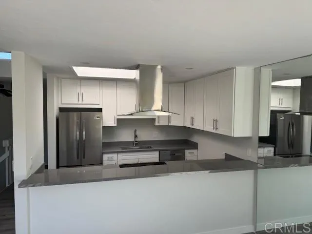 a kitchen with a stove and refrigerator