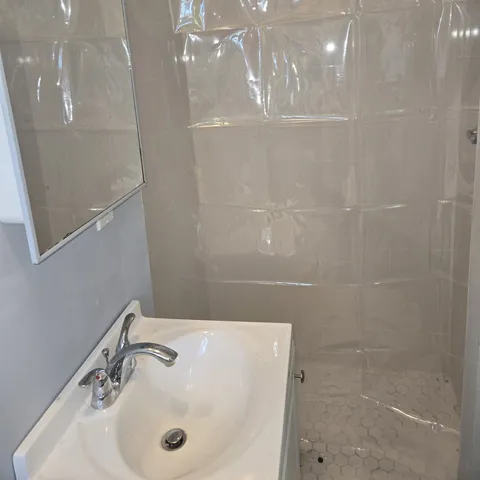 a view of a room with water heater and wooden racks
