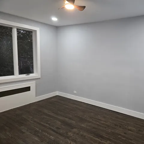 an empty room with wooden floor and closet