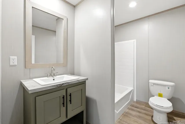 an empty room with wooden floor and a window