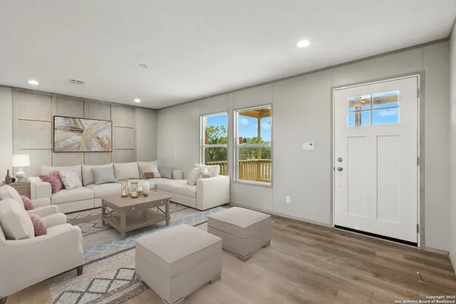 a living room with furniture kitchen view and a refrigerator