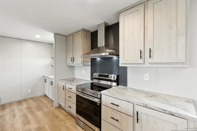 a kitchen with stainless steel appliances granite countertop a sink a stove and refrigerator