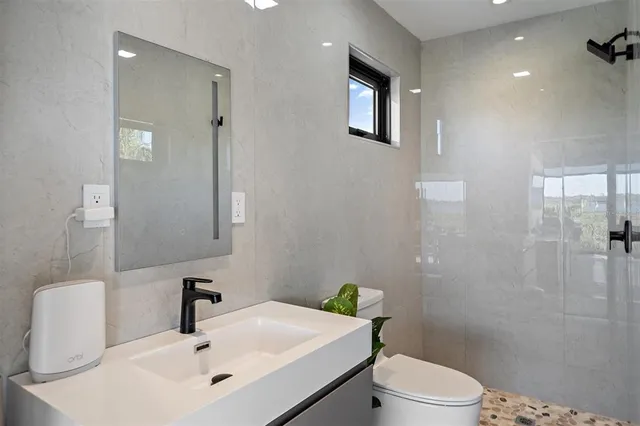 a bedroom with a bed and a view of living room