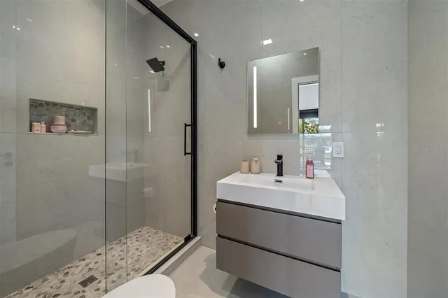 a dining room with furniture and a floor to ceiling window