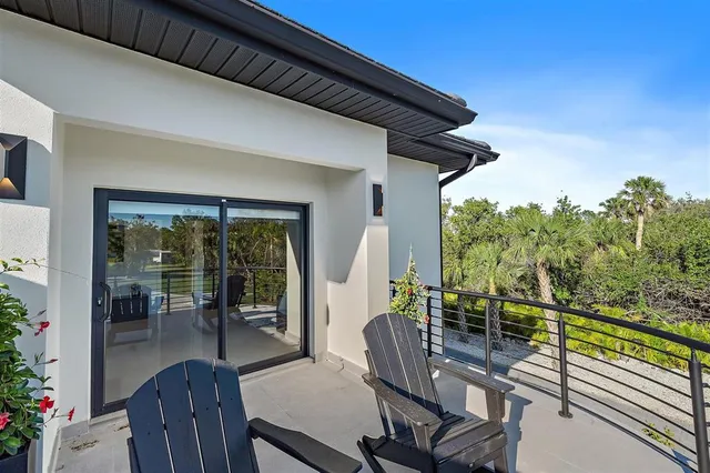 a kitchen with stainless steel appliances kitchen island granite countertop a table chairs sink and cabinets