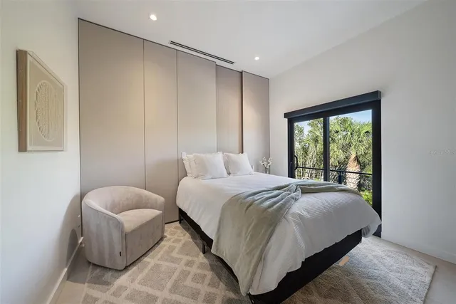 a large kitchen with stainless steel appliances kitchen island a large counter top a stove and a sink