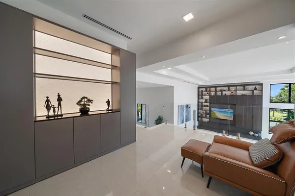 a living room with furniture and a floor to ceiling window