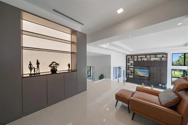 a living room with furniture and a floor to ceiling window