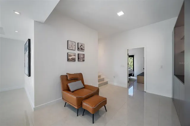 a living room with furniture and a floor to ceiling window