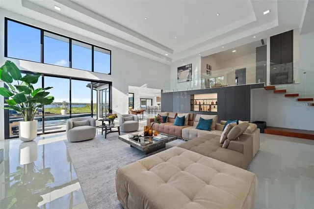 a view of a house with swimming pool and sitting area