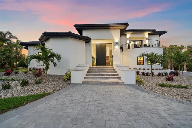 a view of a house with swimming pool and sitting area