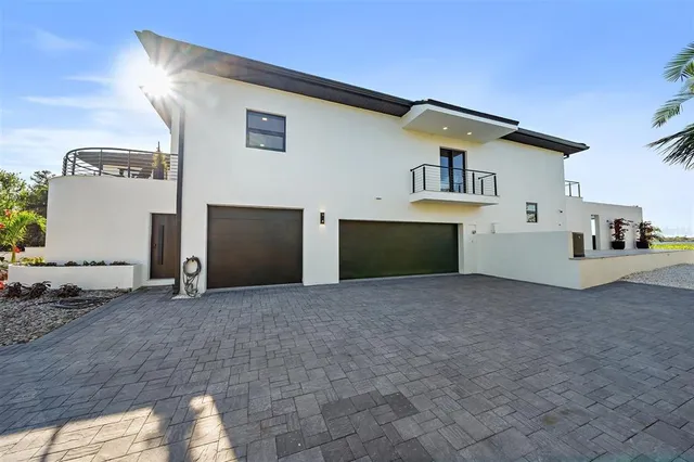 a view of a house with swimming pool in front of it