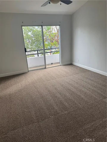 an empty room with an outdoor view and a window