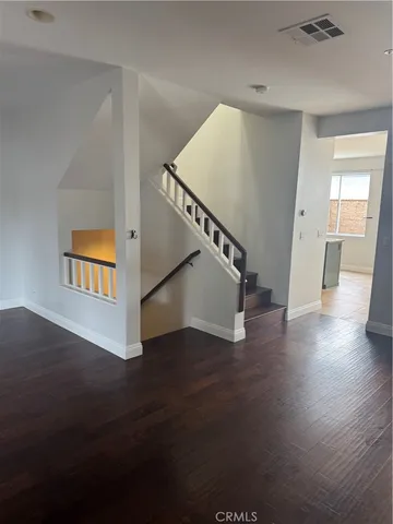 a view of an entryway with wooden floor