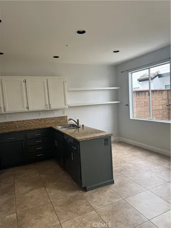 a kitchen with a cabinets and a stove top oven