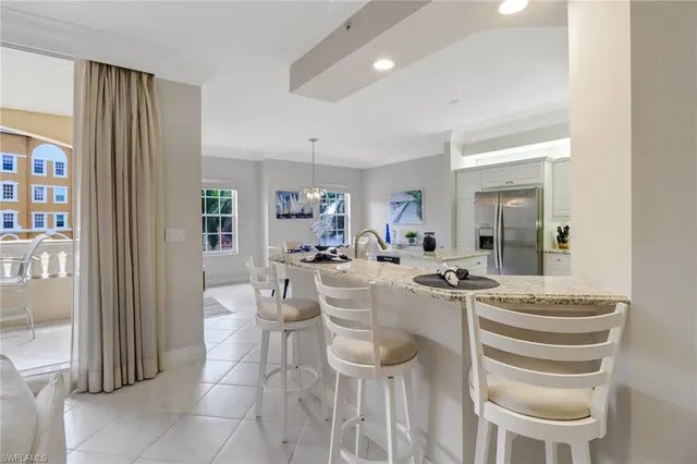 a view of a dining room with furniture and a potted plant
