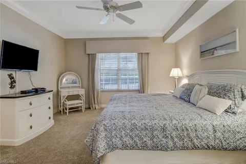 a bedroom with a large bed and a flat screen tv