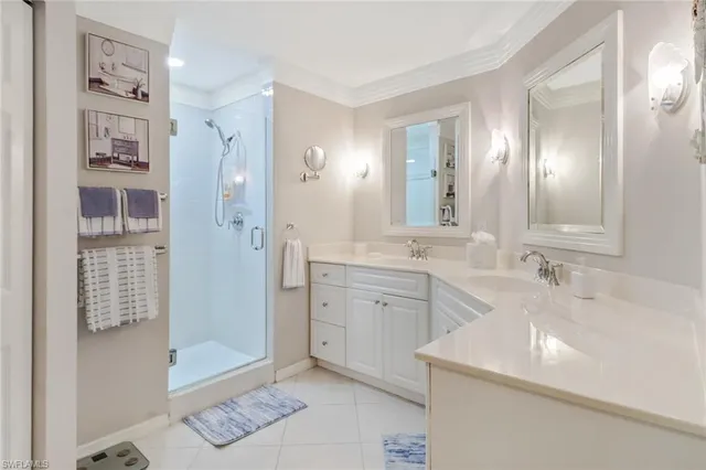 a spacious bathroom with a shower sink and mirror