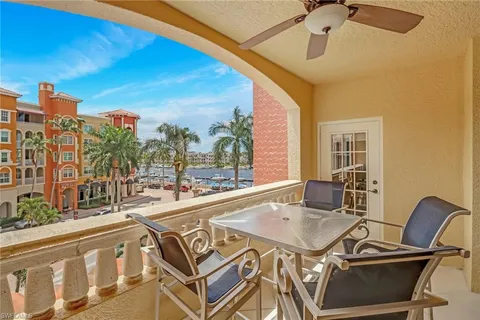a view of a balcony with table and chairs