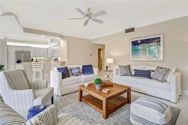 a living room with furniture a rug and a chandelier
