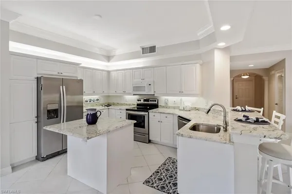 a kitchen with cabinets a sink and appliances