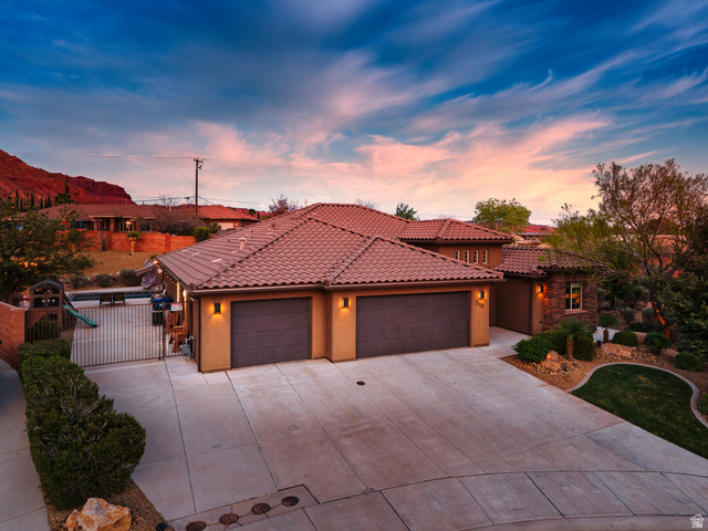 210 Talon Court Ivins, UT 84738 - Photo 4 of 60 Mediterranean / spanish home featuring a garage, driveway, stucco siding, and a gate