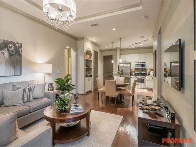 a living room with furniture and a chandelier