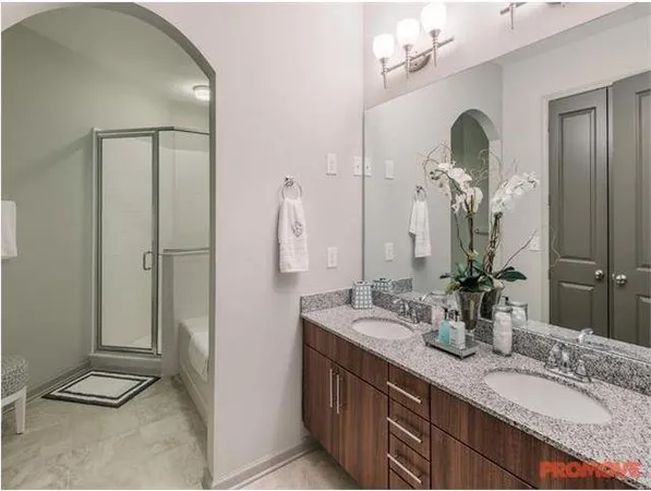 a bathroom with a double vanity sink and a mirror
