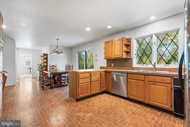 a kitchen with a sink refrigerator and window