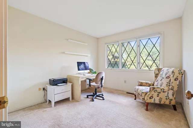 a bedroom with a bed and a lamp