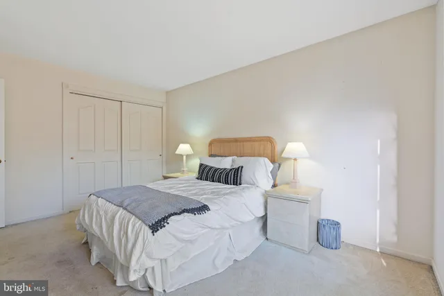 a bedroom with a bed wooden floor and window