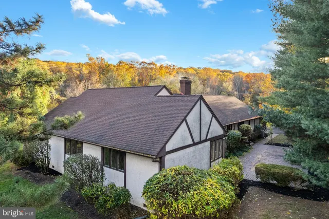 a view of a house with wooden fence
