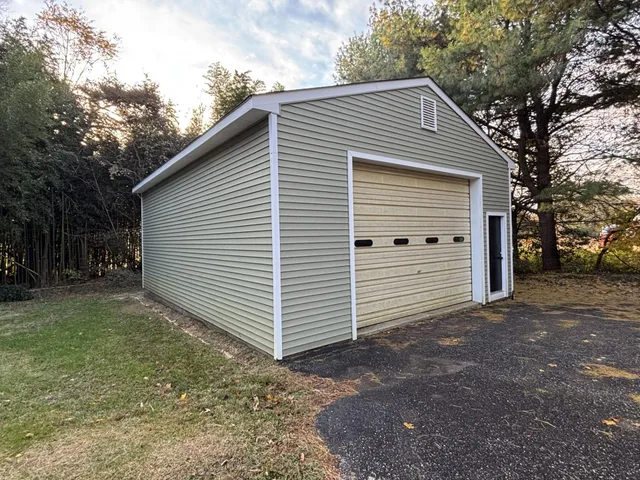 a view of a house with a yard and garage