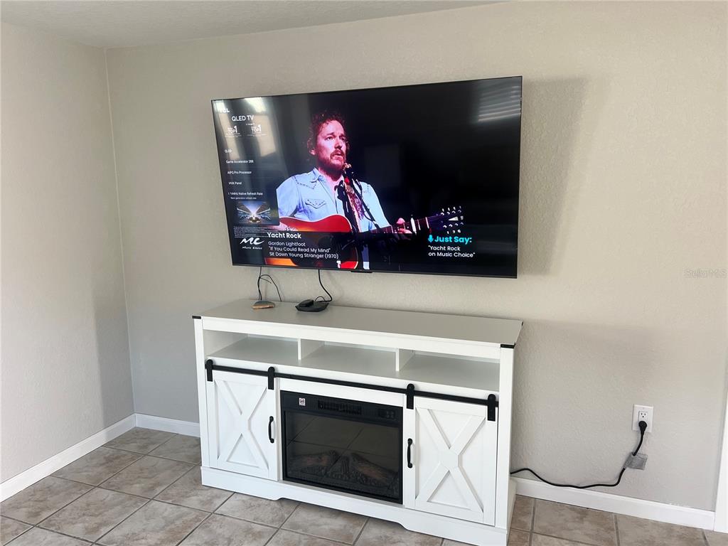6154 Midnight Pass Road, Unit B03 Sarasota, FL 34242 - Photo 6 of 11 a living room with furniture and a flat screen tv
