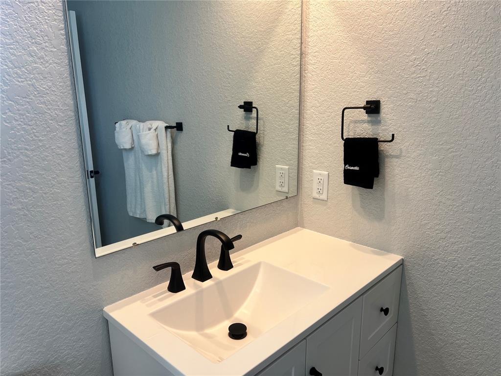 6154 Midnight Pass Road, Unit B03 Sarasota, FL 34242 - Photo 8 of 11 a bathroom with a sink and a mirror