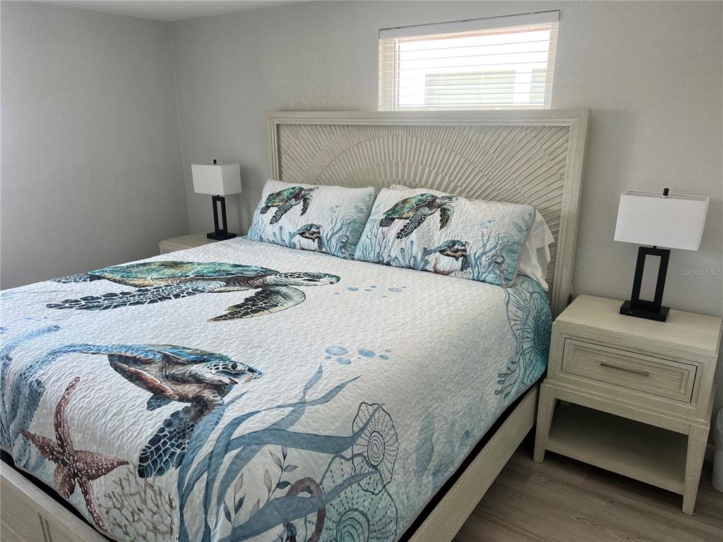 6154 Midnight Pass Road, Unit B03 Sarasota, FL 34242 - Photo 9 of 11 a bedroom with a bed and a window