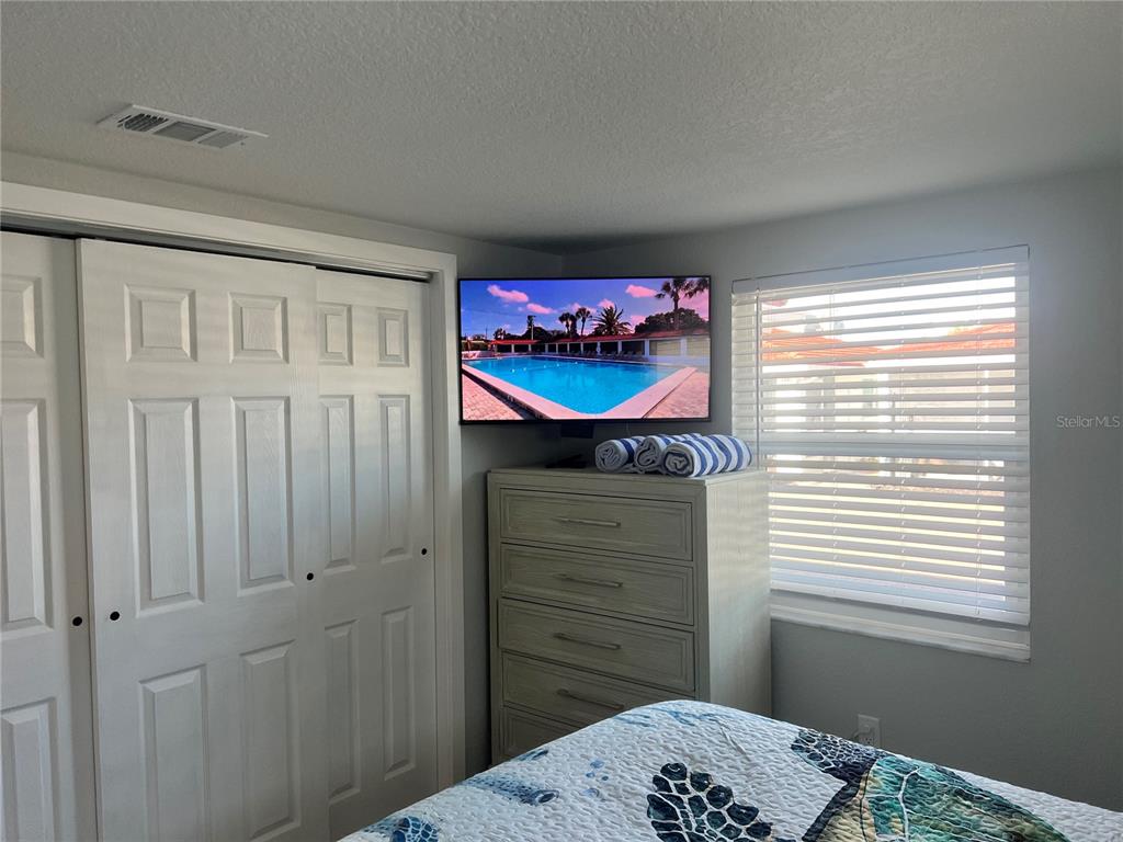 6154 Midnight Pass Road, Unit B03 Sarasota, FL 34242 - Photo 10 of 11 a bedroom with a bed and a window
