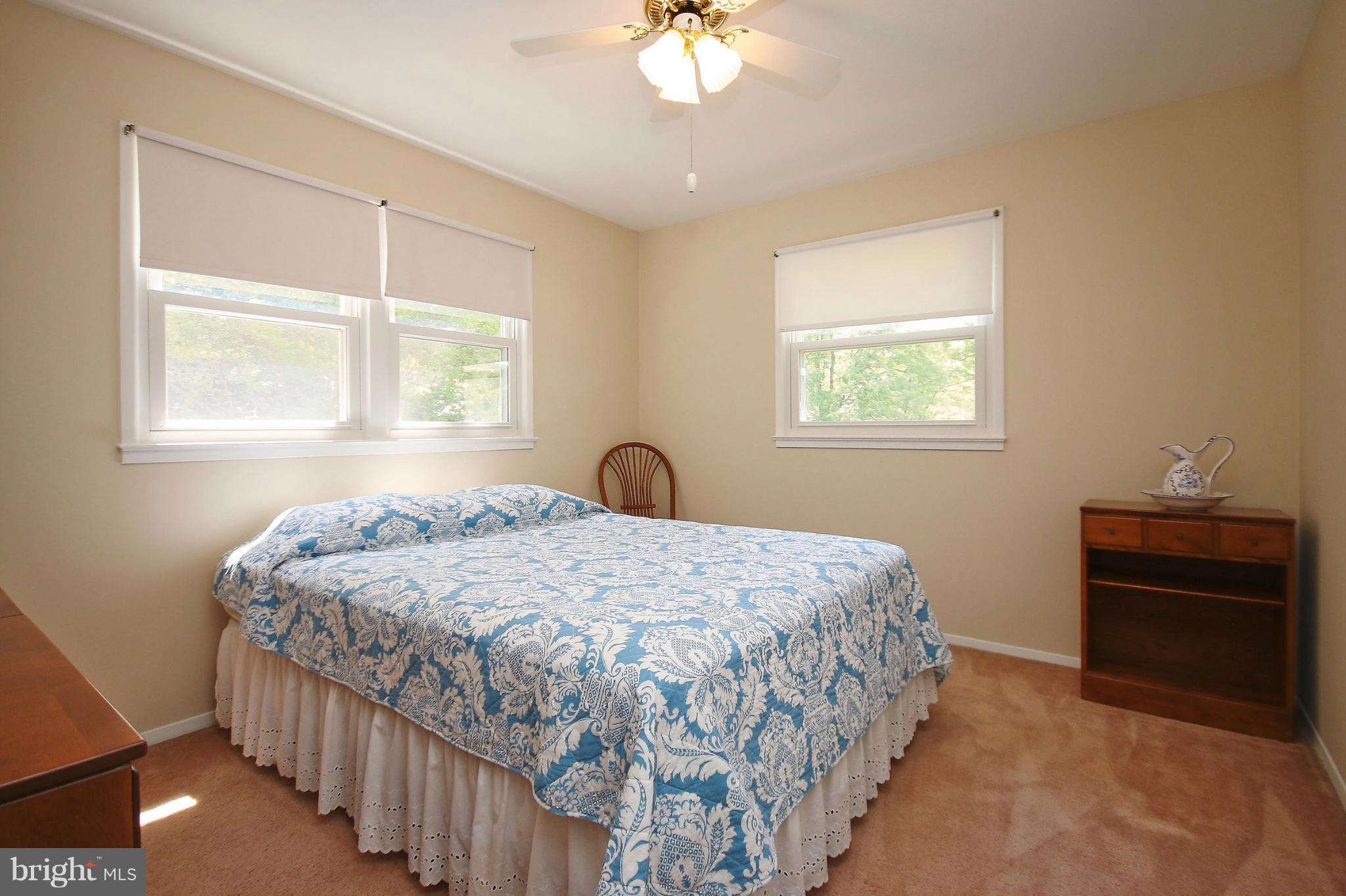 7927 Ellet Road Springfield, VA 22151 - Photo 18 of 30 a bedroom with a bed and a chandelier
