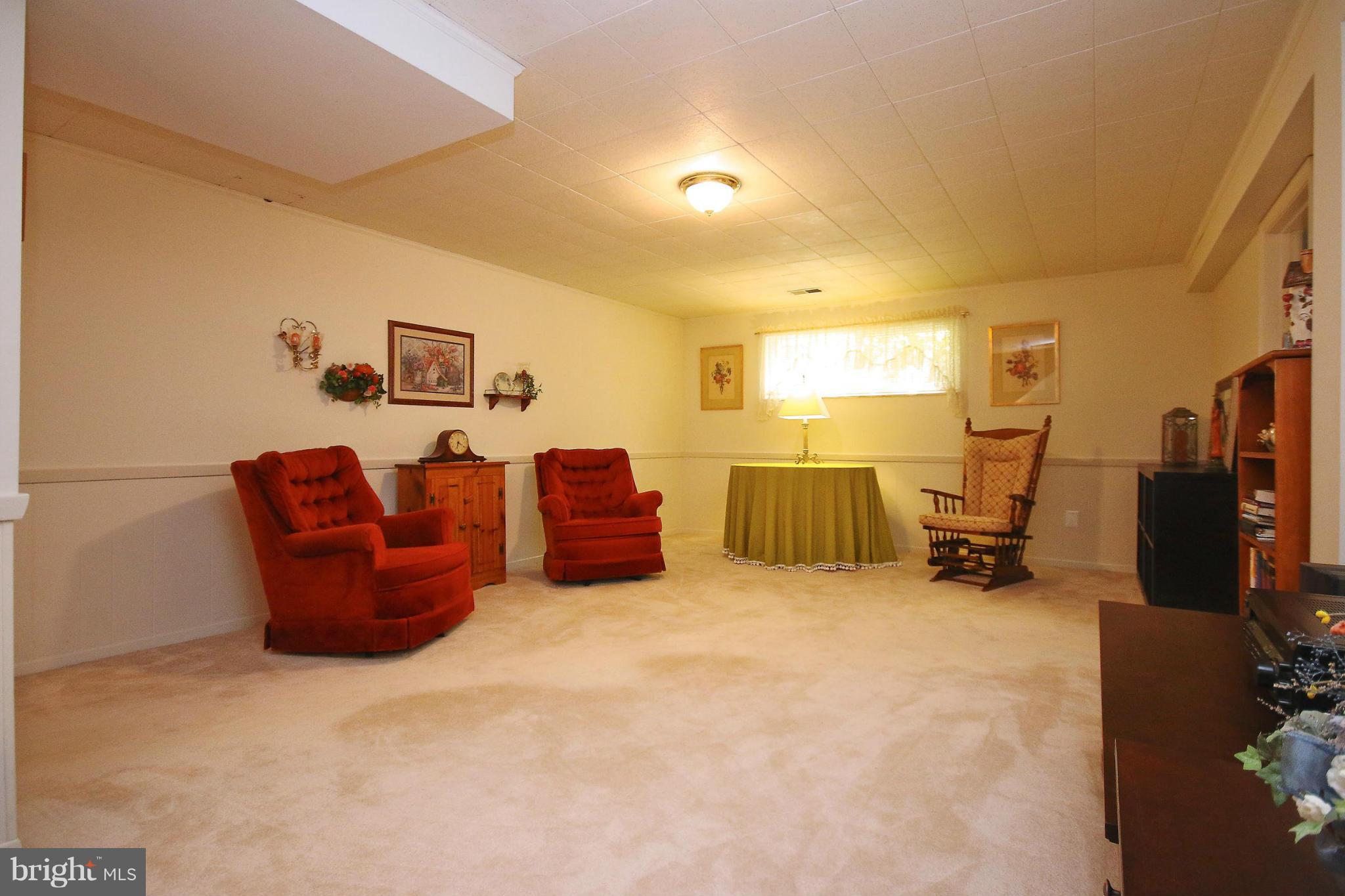 7927 Ellet Road Springfield, VA 22151 - Photo 21 of 30 a living room with furniture gym equipment and a flat screen tv
